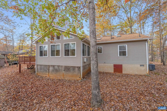 rear view of house with central AC unit and a wooden deck