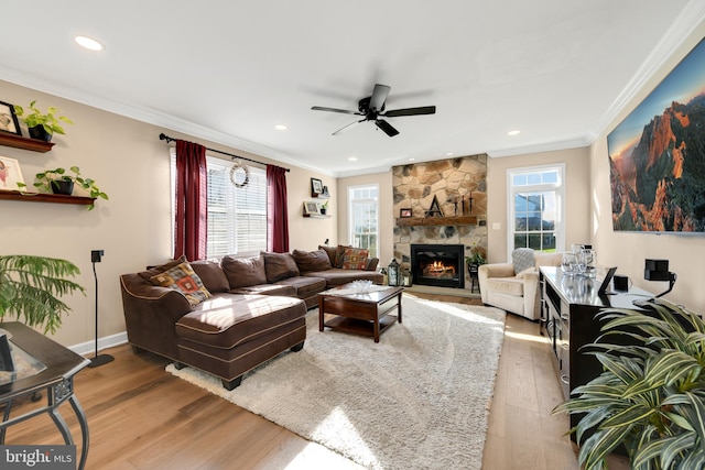 living room with a wealth of natural light, hardwood / wood-style flooring, and crown molding