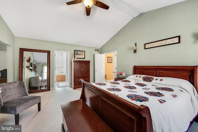 bedroom with ensuite bathroom, light colored carpet, ceiling fan, and vaulted ceiling