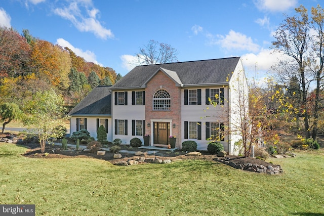 colonial inspired home with a front yard