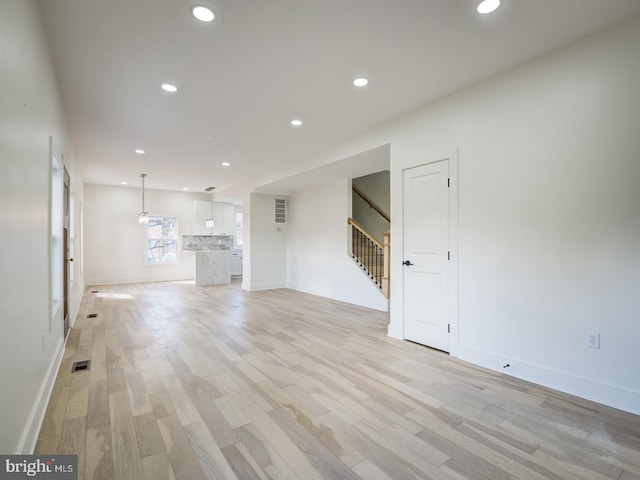 unfurnished living room with light wood-type flooring