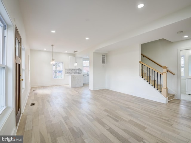 unfurnished living room featuring light hardwood / wood-style flooring