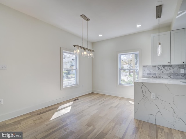 dining area with plenty of natural light and light hardwood / wood-style floors