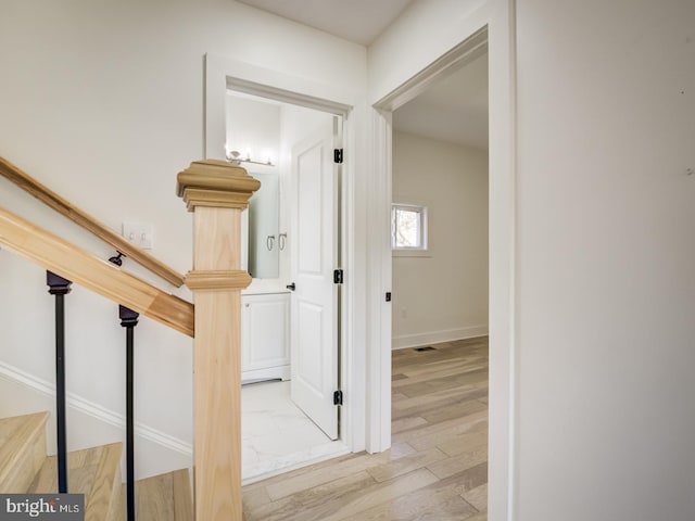 hallway with light hardwood / wood-style flooring