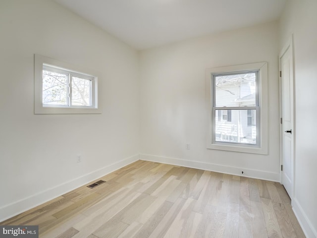 spare room featuring light wood-type flooring