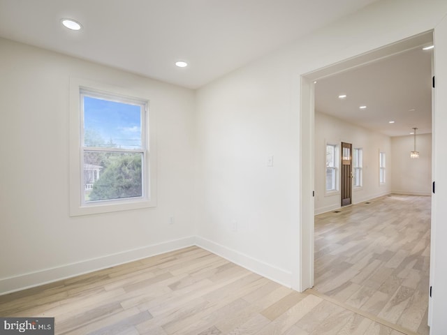 unfurnished room with light hardwood / wood-style floors