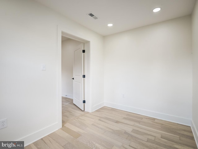 empty room with light hardwood / wood-style flooring