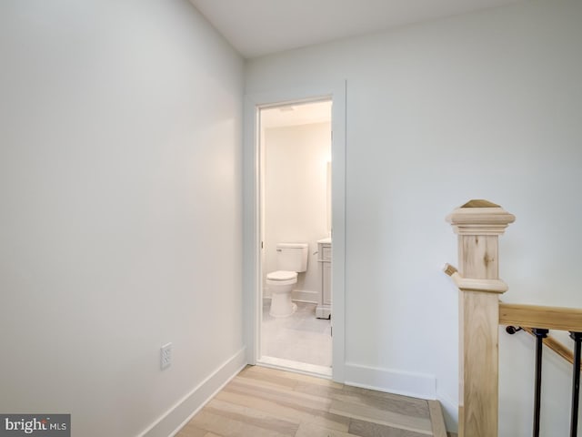 bathroom with wood-type flooring and toilet