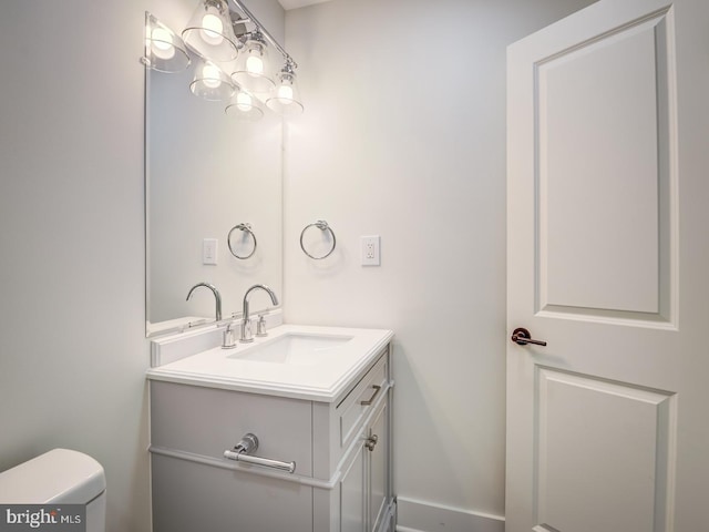 bathroom featuring vanity and toilet