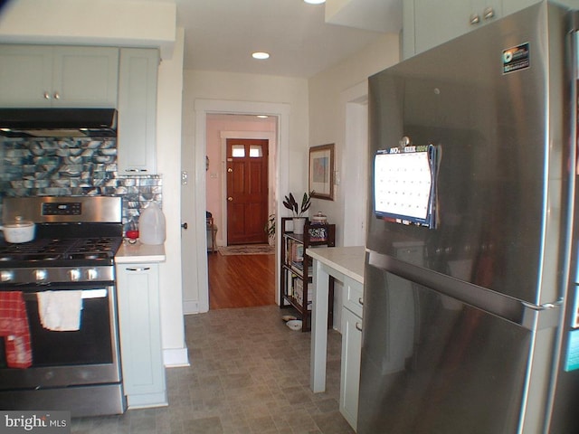 kitchen featuring range hood, decorative backsplash, light hardwood / wood-style floors, and stainless steel appliances