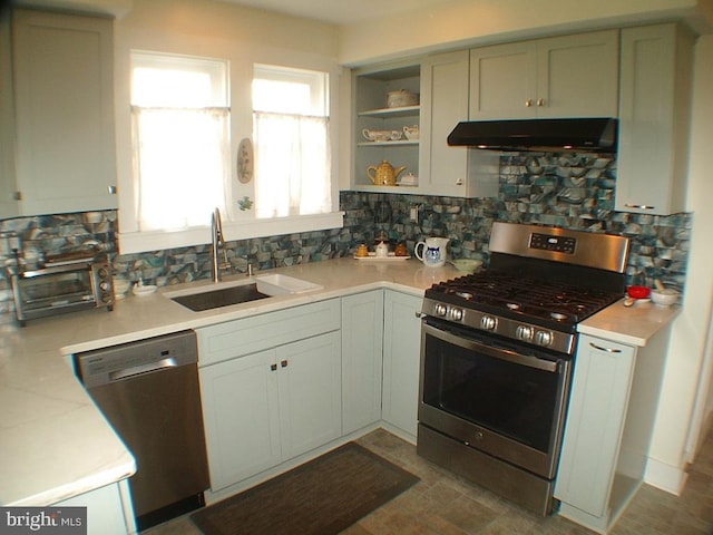 kitchen featuring tasteful backsplash, appliances with stainless steel finishes, and sink