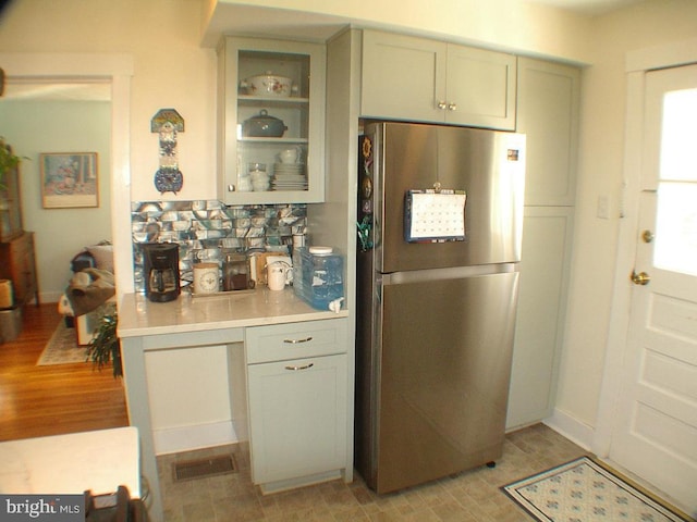 kitchen featuring light hardwood / wood-style flooring and stainless steel refrigerator