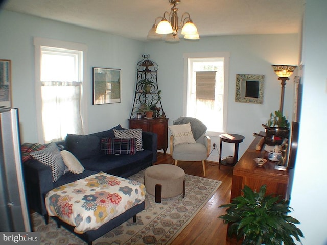 living room with hardwood / wood-style flooring and a chandelier