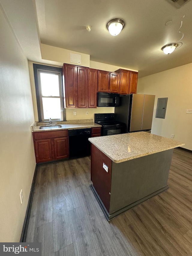 kitchen featuring black appliances, dark wood-type flooring, and sink