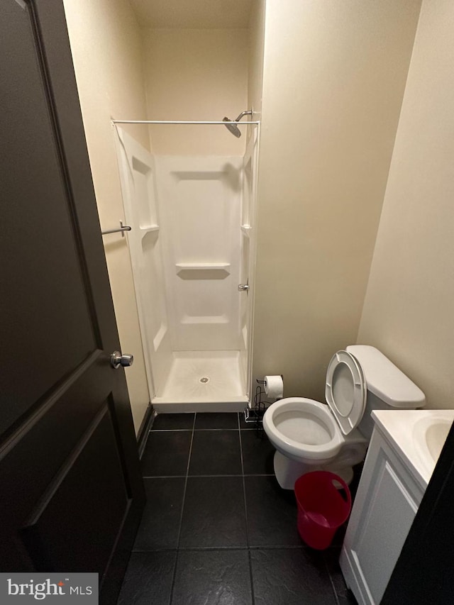 bathroom featuring vanity, walk in shower, and tile patterned flooring