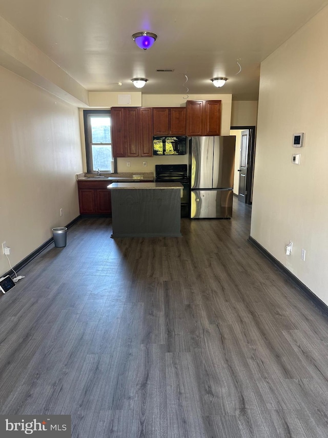 kitchen featuring dark hardwood / wood-style floors, black appliances, and a center island