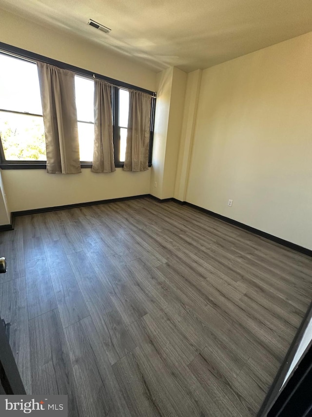 spare room featuring dark hardwood / wood-style floors