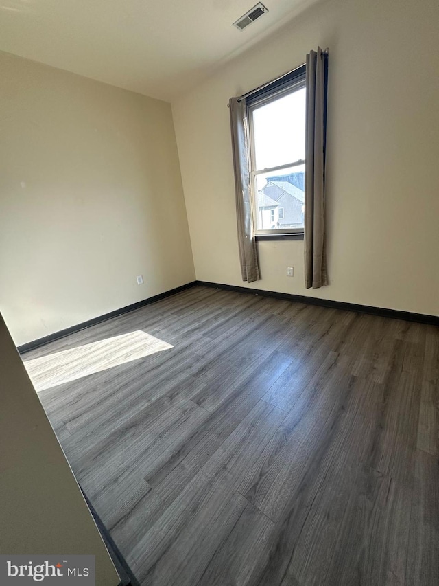 empty room with wood-type flooring