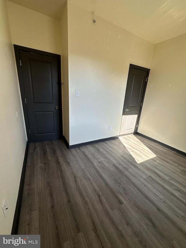 empty room with dark hardwood / wood-style floors