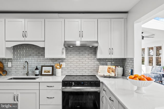 kitchen featuring white cabinetry, decorative backsplash, sink, and stainless steel electric stove