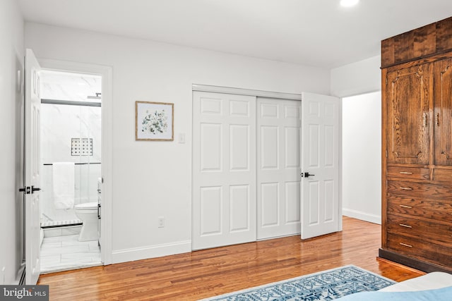 bedroom with wood-type flooring and a closet