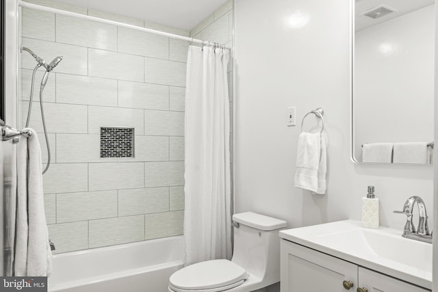 full bathroom featuring shower / bath combo with shower curtain, vanity, and toilet