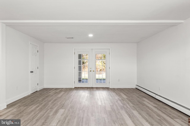 unfurnished room with light wood-type flooring, a baseboard heating unit, and french doors