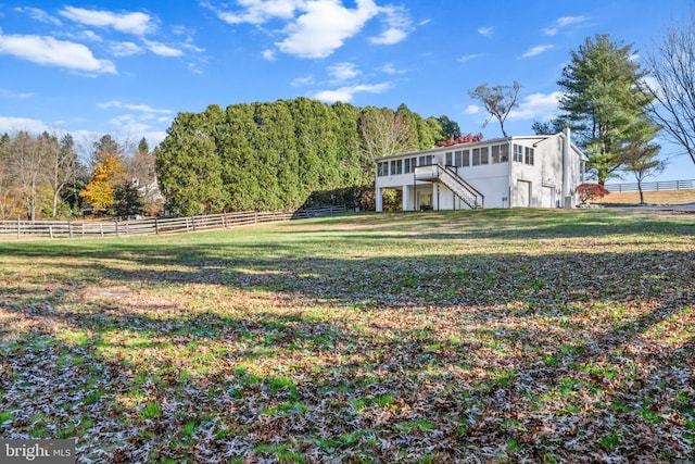 view of yard with a rural view and a wooden deck