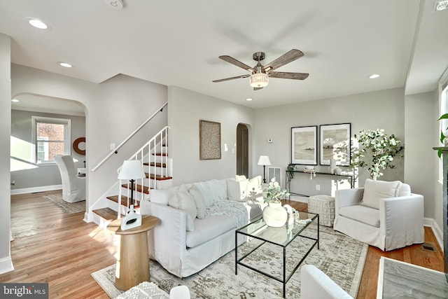 living room with ceiling fan and light hardwood / wood-style floors