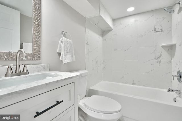 full bathroom featuring toilet, vanity, and tiled shower / bath combo