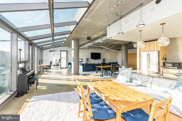 dining area featuring lofted ceiling with skylight and a wealth of natural light