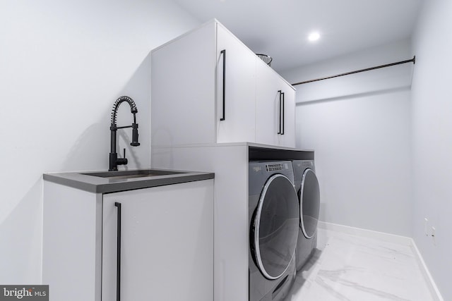 laundry room featuring separate washer and dryer, sink, and cabinets