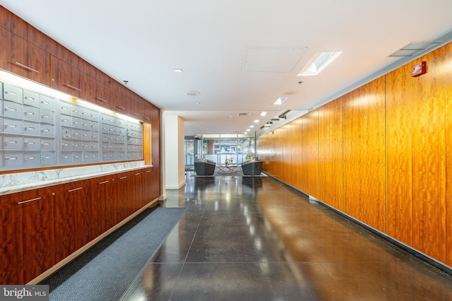 corridor with mail boxes and wooden walls