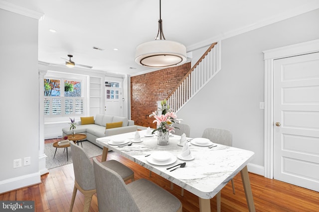 dining area featuring light hardwood / wood-style flooring, ceiling fan, and crown molding