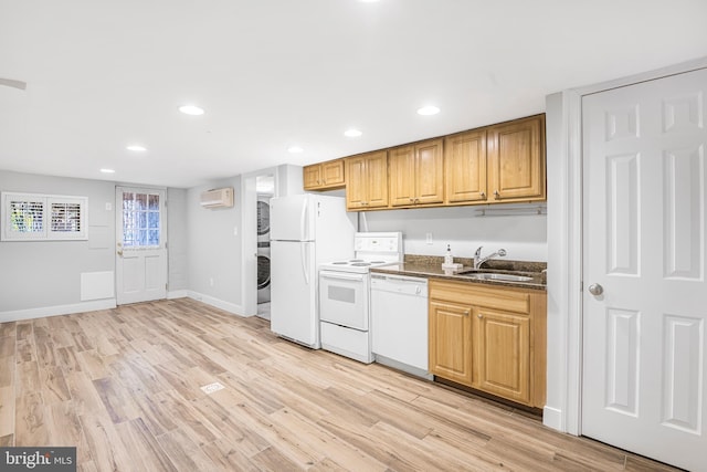 kitchen with light hardwood / wood-style floors, white appliances, sink, and an AC wall unit