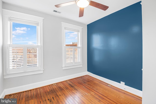 spare room featuring hardwood / wood-style floors and ceiling fan