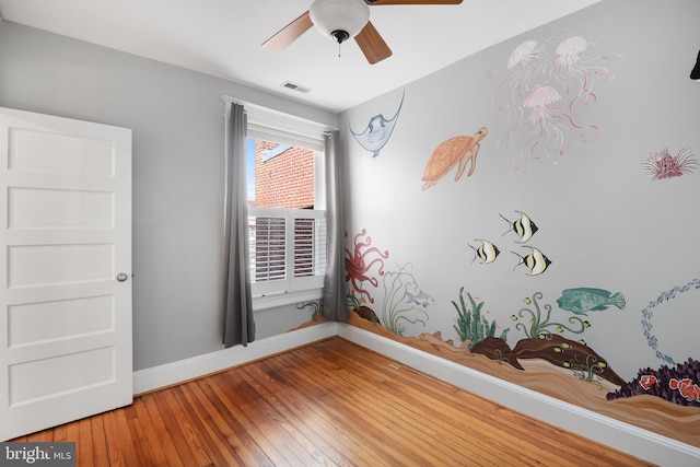 spare room with ceiling fan and hardwood / wood-style floors