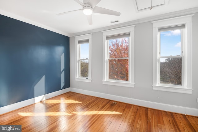 spare room with hardwood / wood-style floors, ceiling fan, and crown molding