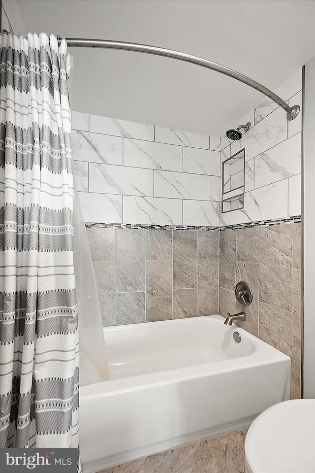 bathroom featuring shower / bath combo with shower curtain