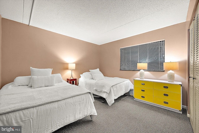 carpeted bedroom with a textured ceiling and a closet