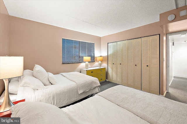 carpeted bedroom featuring a textured ceiling and a closet