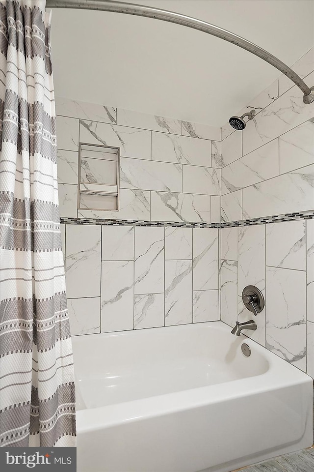 bathroom with shower / bathtub combination with curtain