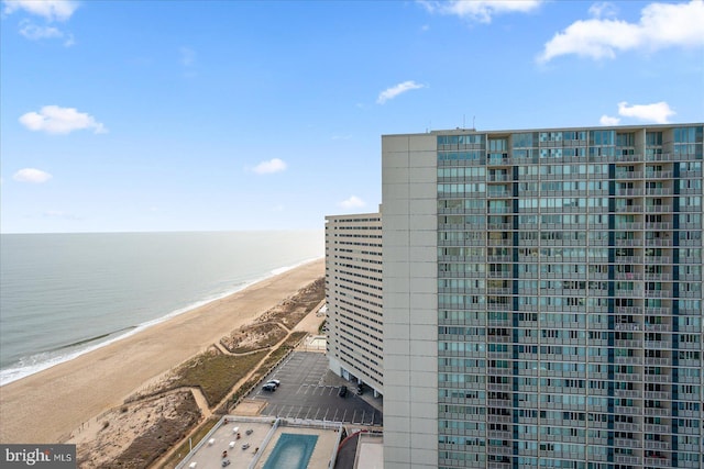 view of building exterior featuring a view of the beach and a water view