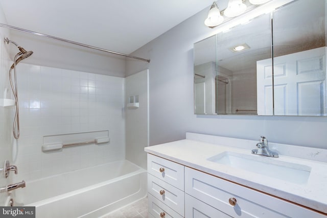 bathroom featuring vanity and tiled shower / bath