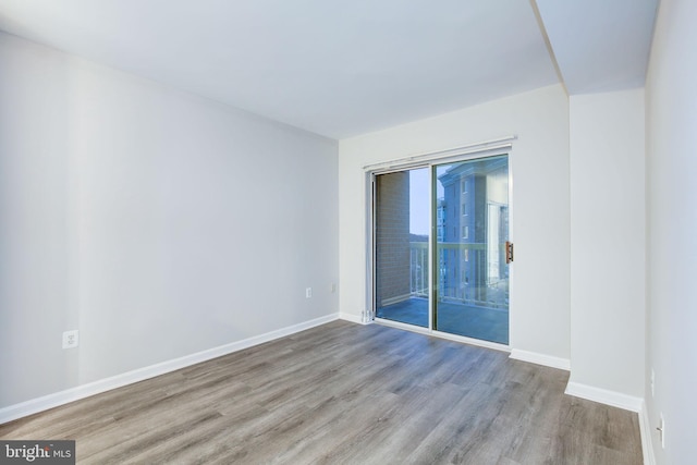 unfurnished room with hardwood / wood-style floors