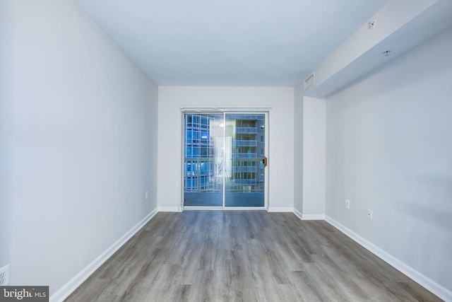 empty room with light hardwood / wood-style floors