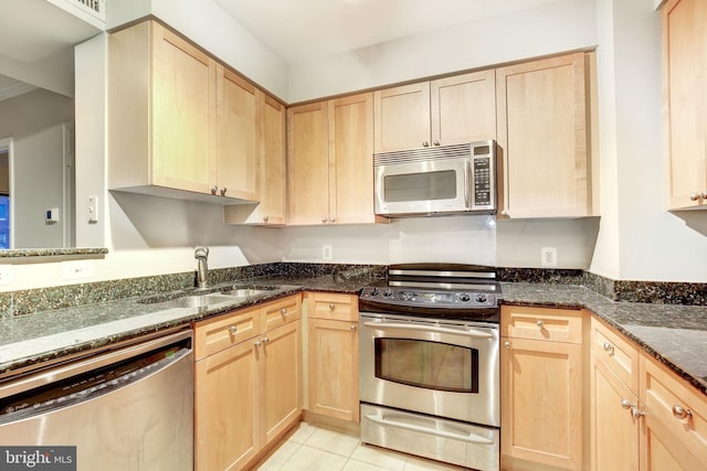 kitchen featuring light brown cabinets, sink, and appliances with stainless steel finishes