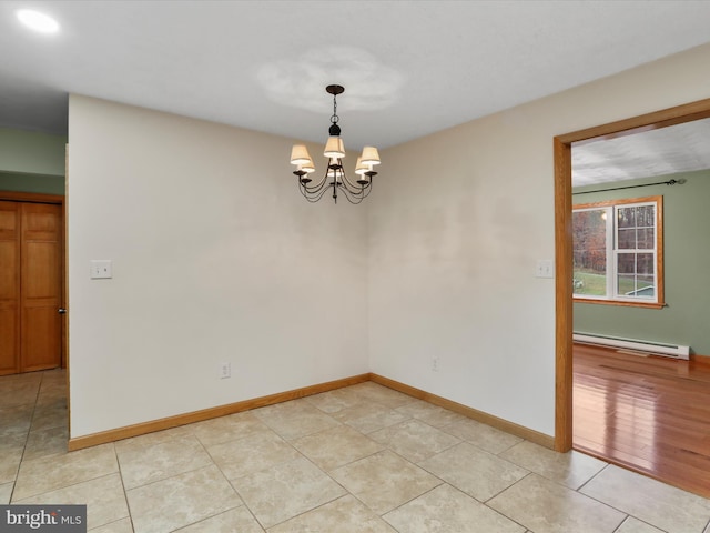 spare room with a chandelier, light hardwood / wood-style floors, and a baseboard radiator