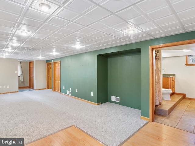 basement with hardwood / wood-style floors