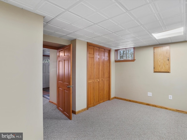 basement featuring light carpet